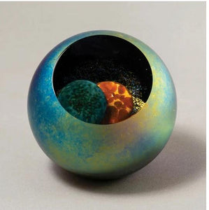 Glass Eye Studio Paperweight that is multicolored and clear